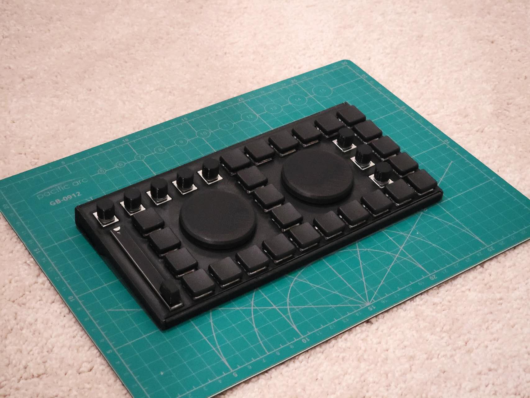 Black custom keyboard prototype with two rotary controls and programmable keys